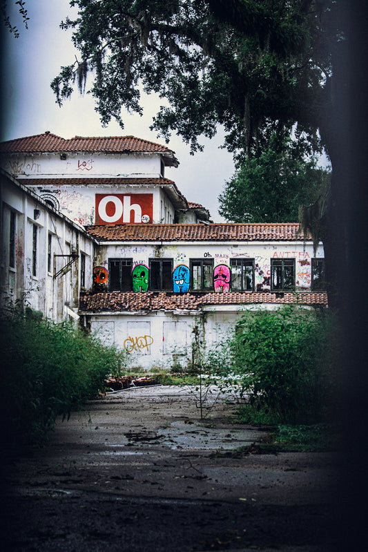 A photograph featuring an urban exploration subject with graffiti on the walls and a dilapidated building structure.